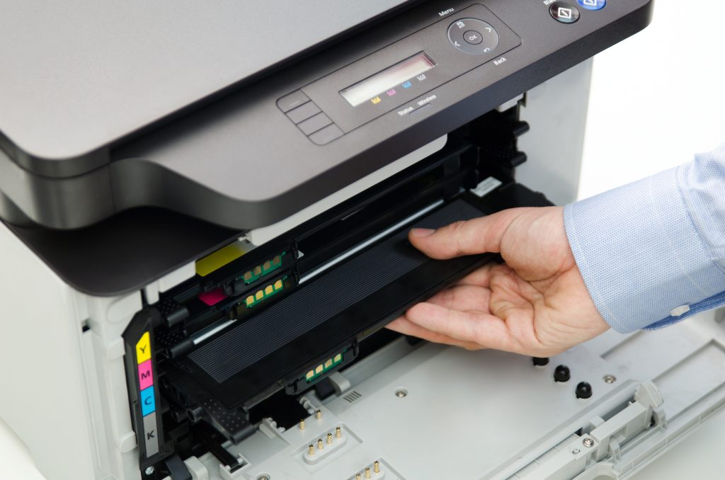 Man replacing toner in laser printer